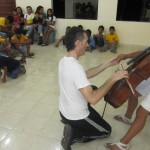 Alalay children are given the opportunity to try the cello